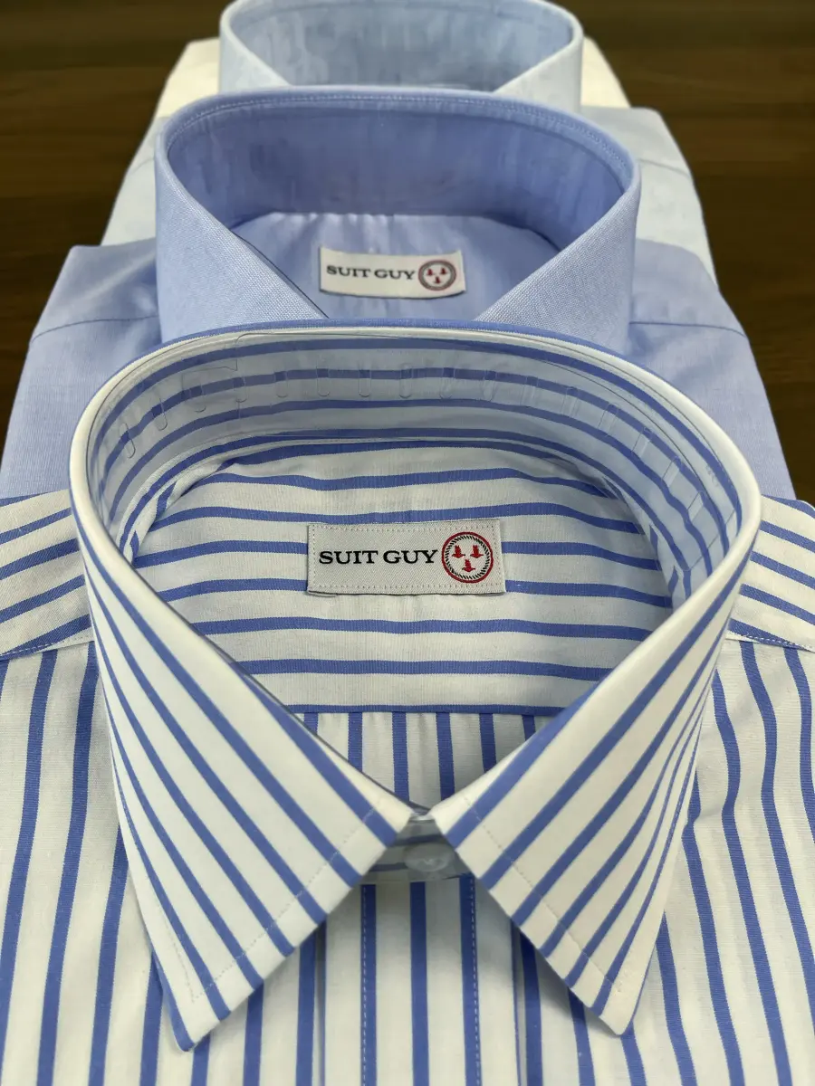Three custom dress shirts stacked, with the collars showing