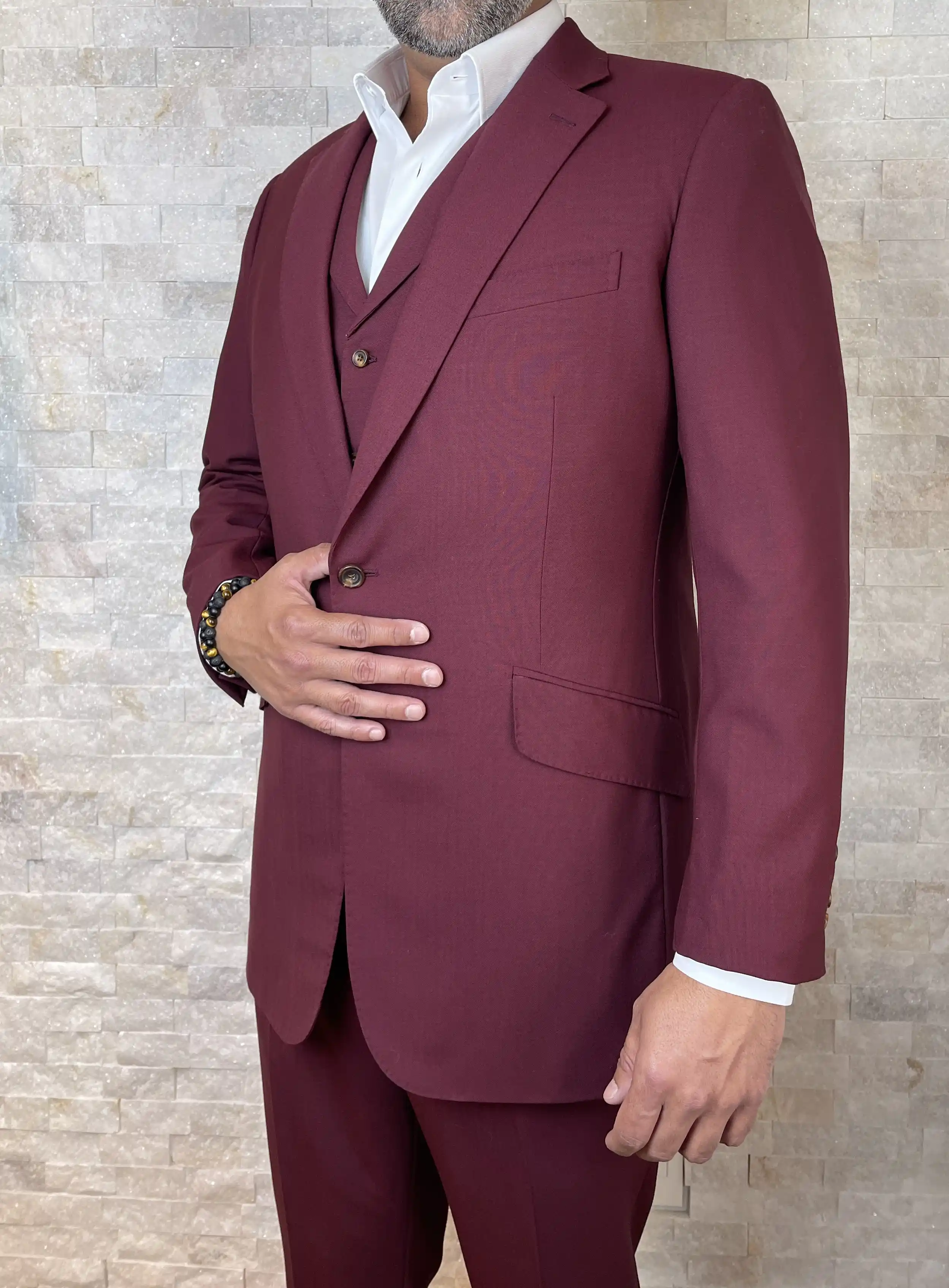 A custom burgundy three-piece suit with a white shirt