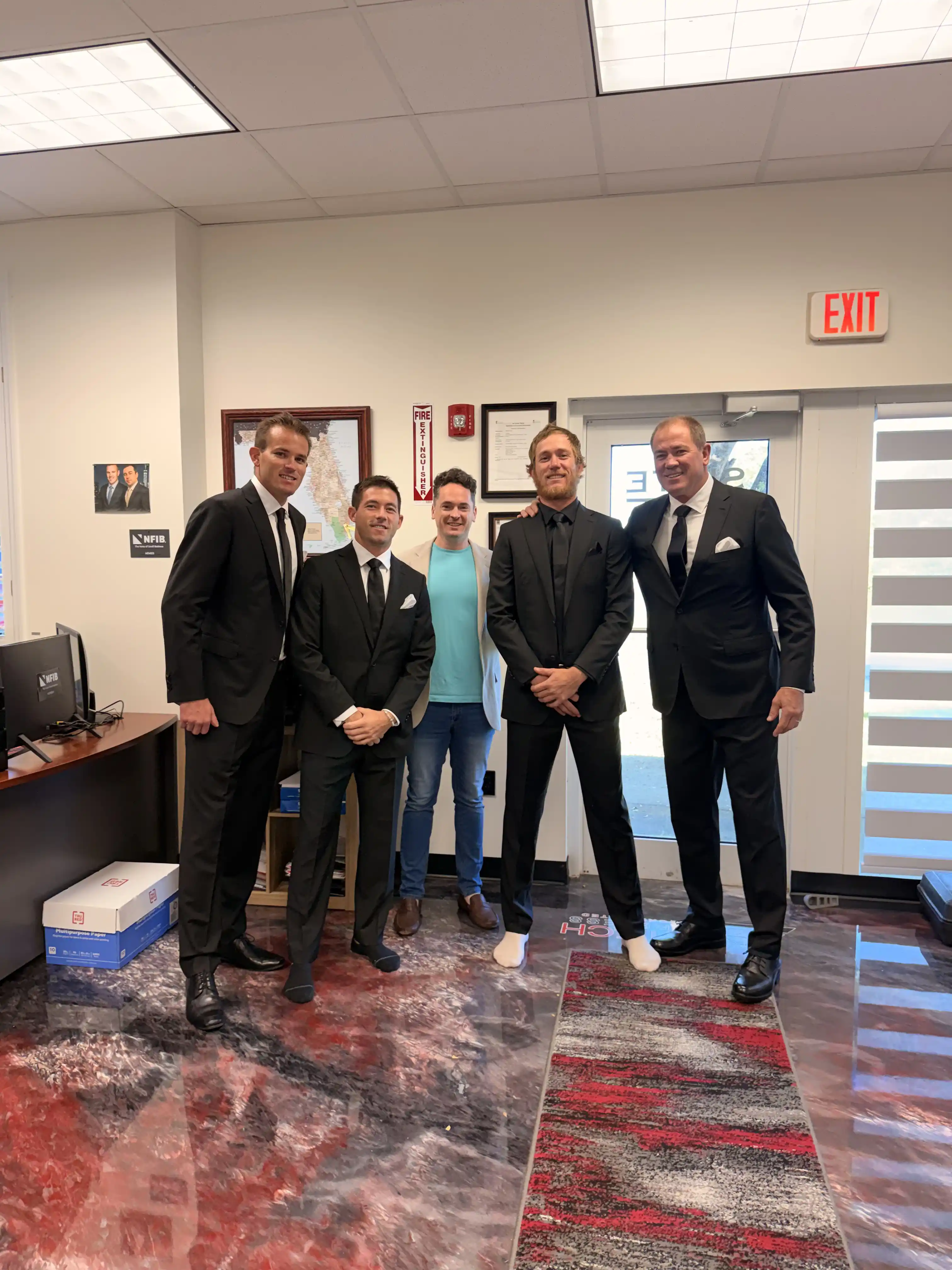 Wedding party in matching custom black three-piece suits by Florida Suit Guy, Fort Myers FL