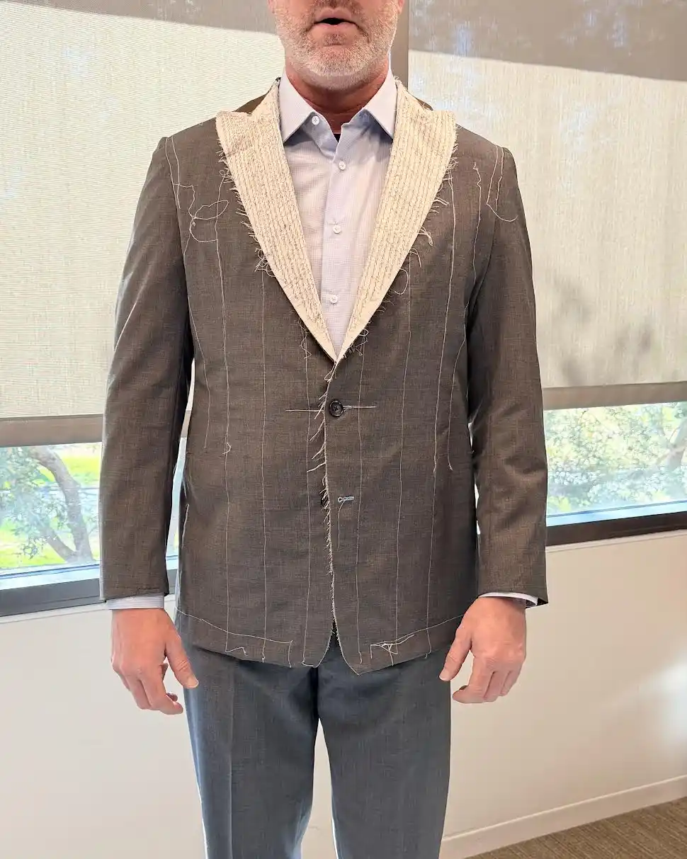 Tailor assessing fabric tension on first-fit garment prototype, Florida Suit Guy