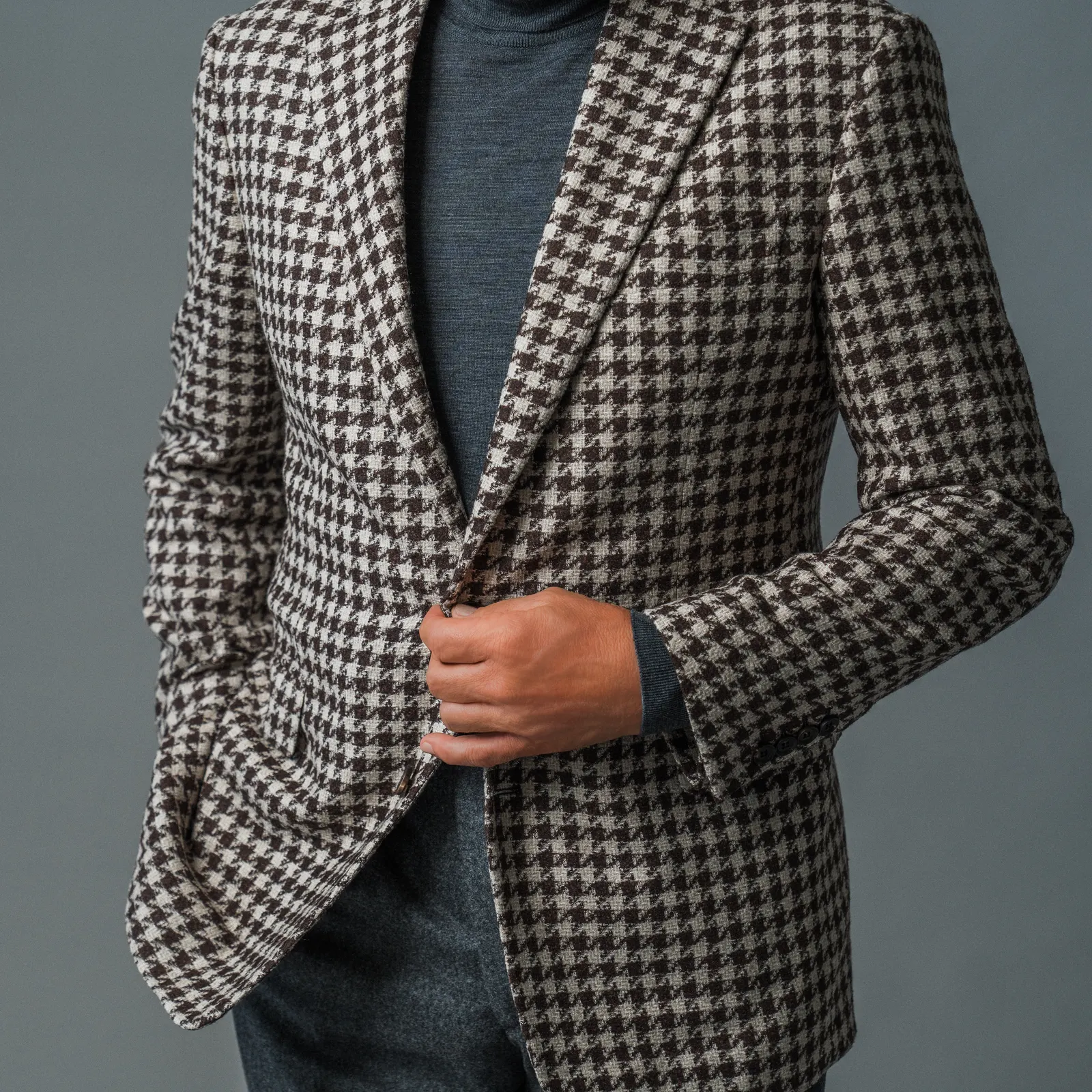 Close view of a brown and cream houndstooth jacket