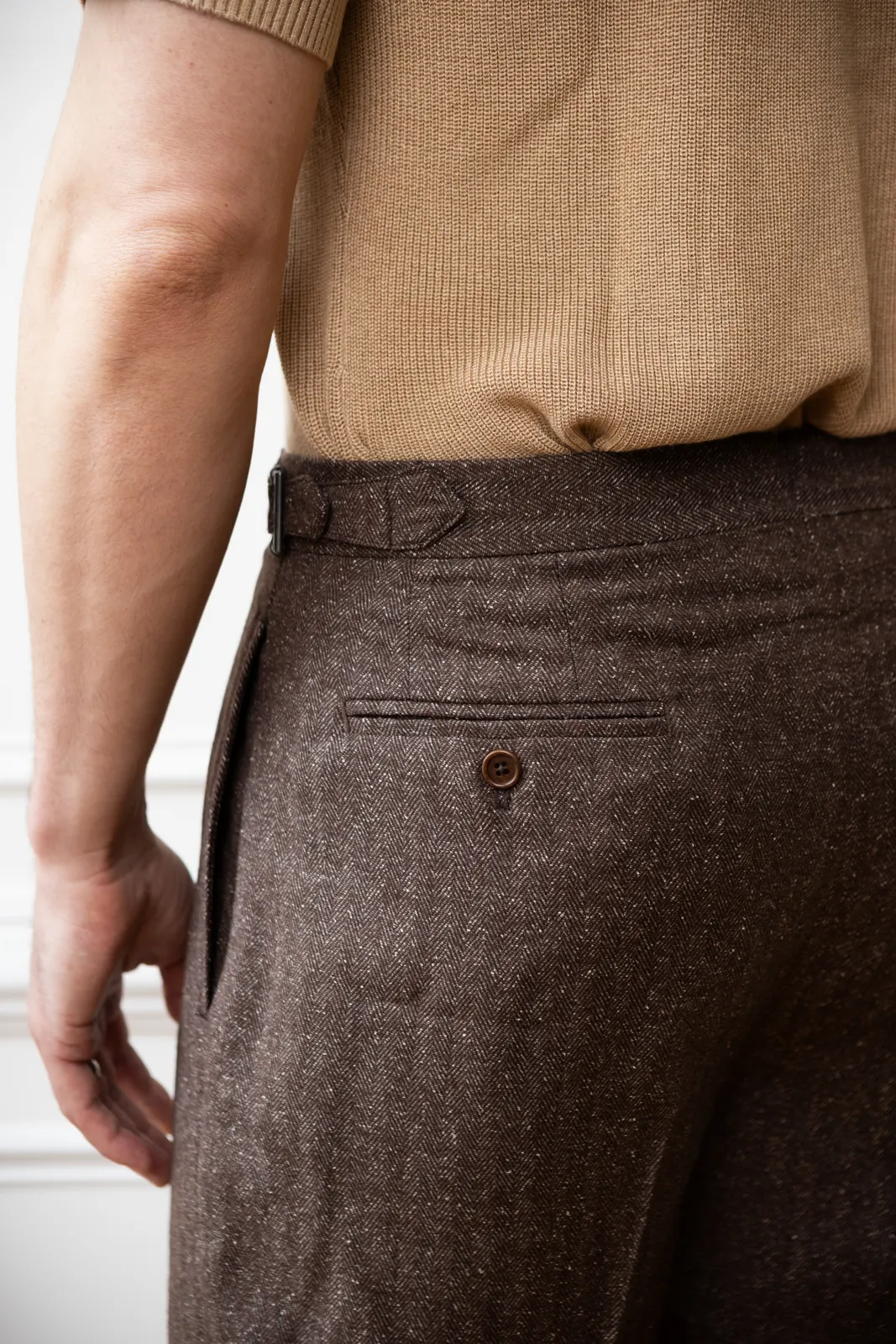 Brown tweed trousers with a side adjuster and a back pocket