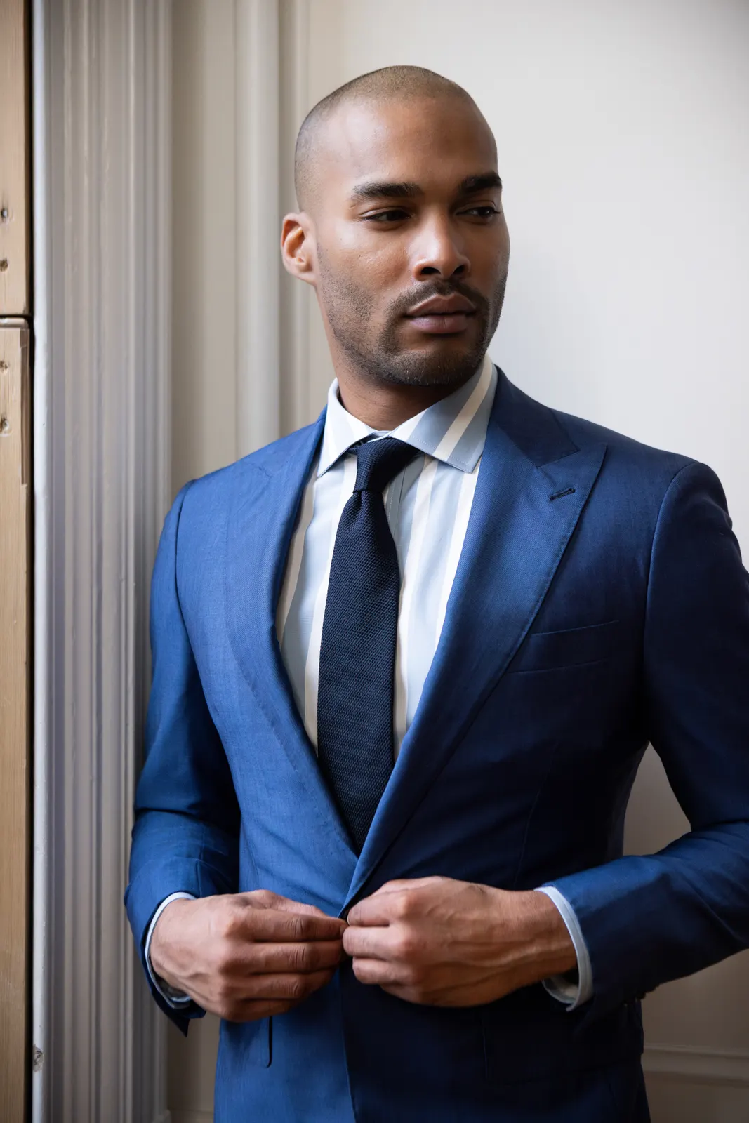 A bright blue American Made suit jacket buttoned at the waist