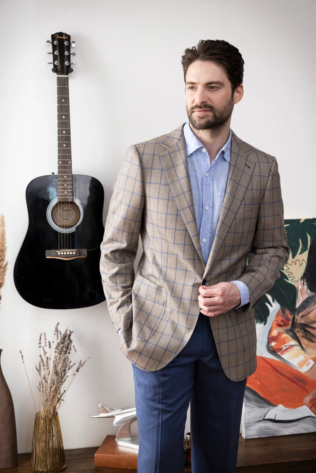 A tan windowpane sport coat over a light blue shirt