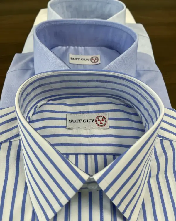 Three custom dress shirts stacked, with the collars showing