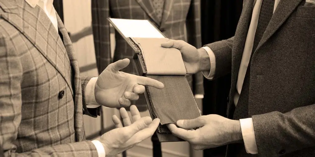 Aaron McGill measuring a client for a custom suit in Fort Myers, Florida