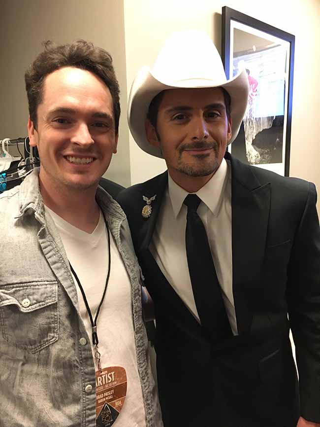brad paisley and aaron mcgill backstage at the cma awards with brad wearing his iconic hat and a custom jacket