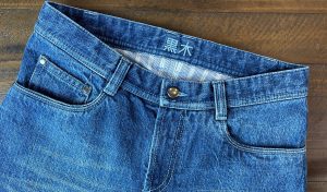blue custom jeans on wood background